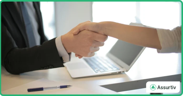 Two employees are handshaking for the success of integrated GRC maturity